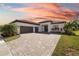 Beautiful single-story home boasts a paver driveway, lush landscaping and a three car garage at 4609 Antrim Dr, Sarasota, FL 34240