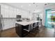 Bright kitchen boasts a large island with seating and views of the pool area through a window at 4609 Antrim Dr, Sarasota, FL 34240