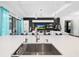 Gourmet kitchen has stainless steel appliances, modern lighting, and an eat-in island with a sink at 4609 Antrim Dr, Sarasota, FL 34240