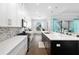 Beautiful kitchen features sleek white cabinetry, stainless steel appliances, and an eat-in island at 4609 Antrim Dr, Sarasota, FL 34240