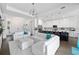 Open concept living area features hardwood flooring, modern lighting and access to the outdoor patio at 4609 Antrim Dr, Sarasota, FL 34240