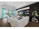 Comfortable living room features hardwood flooring, a tray ceiling, and wall mounted shelving at 4609 Antrim Dr, Sarasota, FL 34240