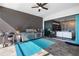 Covered outdoor kitchen with stainless steel grill, fan, turquoise rug, and slider to interior at 4609 Antrim Dr, Sarasota, FL 34240