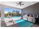Outdoor kitchen with stainless steel appliances, ceiling fan, hammock chair, and pool view at 4609 Antrim Dr, Sarasota, FL 34240