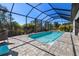 Screened-in pool area featuring brick pavers, a refreshing pool, and outdoor seating, perfect for relaxation at 4609 Antrim Dr, Sarasota, FL 34240