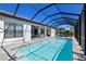 Inviting screened-in pool area with comfortable loungers, a hammock, and a clear, refreshing pool at 4609 Antrim Dr, Sarasota, FL 34240