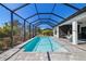 Enclosed pool with pavers and an outdoor grill at 4609 Antrim Dr, Sarasota, FL 34240