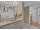 Well-lit bathroom featuring a single sink vanity, neutral tones, and a door leading to a second bathroom area at 6263 Midnight Pass Rd # 105, Sarasota, FL 34242