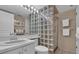 Modern bathroom with a glass block shower, tiled floors, and a neutral color palette at 6263 Midnight Pass Rd # 105, Sarasota, FL 34242