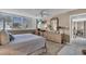 Bright bedroom with neutral color scheme, shuttered windows, ceiling fan, and wicker furniture at 6263 Midnight Pass Rd # 105, Sarasota, FL 34242