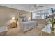 Bright bedroom with neutral color scheme, bedside tables, ceiling fan, and shuttered windows at 6263 Midnight Pass Rd # 105, Sarasota, FL 34242