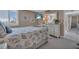 Neutral bedroom with a ceiling fan, decorative pillows, shuttered windows, TV, and light colored furniture at 6263 Midnight Pass Rd # 105, Sarasota, FL 34242