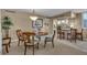 Dining room with chandelier and adjacent kitchen with breakfast bar at 6263 Midnight Pass Rd # 105, Sarasota, FL 34242
