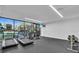 Well-equipped gym featuring treadmills, stationary bikes, free weights, and large windows for natural light at 6263 Midnight Pass Rd # 105, Sarasota, FL 34242