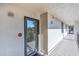 Exterior hallway with view of the surrounding tropical landscaping from the front door at 6263 Midnight Pass Rd # 105, Sarasota, FL 34242