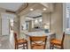 Modern kitchen featuring a breakfast bar with seating and stainless steel appliances at 6263 Midnight Pass Rd # 105, Sarasota, FL 34242