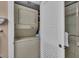 Convenient laundry area with a stacked washer and dryer unit, next to the bathroom at 6263 Midnight Pass Rd # 105, Sarasota, FL 34242