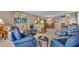 Spacious living room with a comfortable seating arrangement, light fixtures, and an adjacent dining area at 6263 Midnight Pass Rd # 105, Sarasota, FL 34242