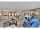 Inviting living room with bright windows and an adjacent dining area at 6263 Midnight Pass Rd # 105, Sarasota, FL 34242