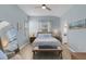 Comfortable bedroom with a ceiling fan, light blue walls, and a wooden bench at 6326 Yellowtop Dr, Lakewood Ranch, FL 34202