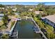 Aerial view of boat docks along canal surrounded by mature trees in waterfront community at 6650 Schooner Bay Cir # 6650, Sarasota, FL 34231
