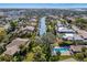 An aerial shot shows a canal lined with residences, boats, and mature trees at 6650 Schooner Bay Cir # 6650, Sarasota, FL 34231