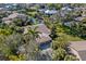 Aerial view of a beautiful home with a three-car garage surrounded by mature landscaping and a well maintained lawn at 6650 Schooner Bay Cir # 6650, Sarasota, FL 34231