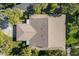 Aerial view of the home showcasing the roof and surrounding lush landscaping and mature trees at 6650 Schooner Bay Cir # 6650, Sarasota, FL 34231
