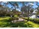 Beautiful backyard featuring a wooden deck, a well manicured lawn, and water access at 6650 Schooner Bay Cir # 6650, Sarasota, FL 34231