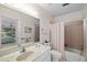 Bathroom with vanity, toilet and shower featuring a decorative wallpaper at 6650 Schooner Bay Cir # 6650, Sarasota, FL 34231