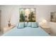 Bright bedroom features decorative pillows and a striking three-panel painting at 6650 Schooner Bay Cir # 6650, Sarasota, FL 34231