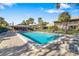 Community pool surrounded by chairs and a beautiful lawn area offering a relaxing outdoor space at 6650 Schooner Bay Cir # 6650, Sarasota, FL 34231
