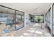 Bright sunroom with tile flooring and plenty of natural light from sliding glass windows at 6650 Schooner Bay Cir # 6650, Sarasota, FL 34231