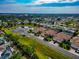 Panoramic aerial view of homes, pristine landscaping, and scenic pond in a tranquil community at 6907 Costa Bella Dr, Bradenton, FL 34209