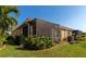 A well maintained backyard and screened in patio featuring beautiful landscaping at 6907 Costa Bella Dr, Bradenton, FL 34209