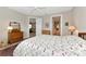 Bright bedroom with a bed that has a floral pattern quilt and neutral walls at 6907 Costa Bella Dr, Bradenton, FL 34209