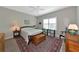 Inviting bedroom with a wooden bed, a large window and natural light at 6907 Costa Bella Dr, Bradenton, FL 34209