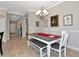 Dining room features a farmhouse-style table with bench seating and elegant decor at 6907 Costa Bella Dr, Bradenton, FL 34209
