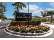 Mirabella community entrance sign surrounded by tropical landscaping and colorful flower beds, set under a bright sky at 6907 Costa Bella Dr, Bradenton, FL 34209