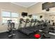 Gym with treadmills, stationary bike, weight bench, tvs and mirrors at 6907 Costa Bella Dr, Bradenton, FL 34209