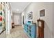 Hallway featuring wood-look tile flooring, a blue console, and neutral walls at 6907 Costa Bella Dr, Bradenton, FL 34209