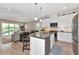 Open-concept kitchen with a large island and modern appliances at 6907 Costa Bella Dr, Bradenton, FL 34209