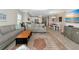 Open concept living room and dining area with stylish decor and wood-look tile flooring at 6907 Costa Bella Dr, Bradenton, FL 34209