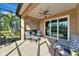 Relaxing screened-in lanai featuring comfortable seating and ceiling fan, perfect for enjoying the outdoors at 6907 Costa Bella Dr, Bradenton, FL 34209