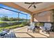 Inviting screened-in patio showcasing comfortable chairs and manicured backyard at 6907 Costa Bella Dr, Bradenton, FL 34209