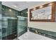 Modern bathroom featuring a tiled shower, tub, and a large framed mirror over a jacuzzi tub at 7912 Desoto Memorial Hwy, Bradenton, FL 34209