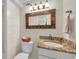 Cozy bathroom featuring granite countertop, decorative mirror and neutral color palette at 7912 Desoto Memorial Hwy, Bradenton, FL 34209