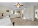 Neutral bedroom featuring carpet, a ceiling fan, and an ensuite bathroom at 7912 Desoto Memorial Hwy, Bradenton, FL 34209