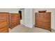 Bedroom featuring two wooden dressers, a wardrobe with a white louvered door and carpeted floor at 7912 Desoto Memorial Hwy, Bradenton, FL 34209