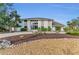 Beautiful two-story home featuring large windows, stone accents, and lush landscaping in a lovely neighborhood at 7912 Desoto Memorial Hwy, Bradenton, FL 34209